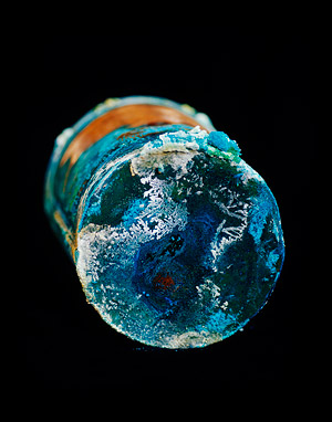 copper can with multicolored corrosion