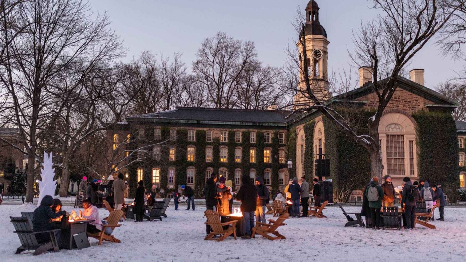 Students stay warm thanks to campfires set up on Cannon Green as part of the Wintersession Kick-off Festival.