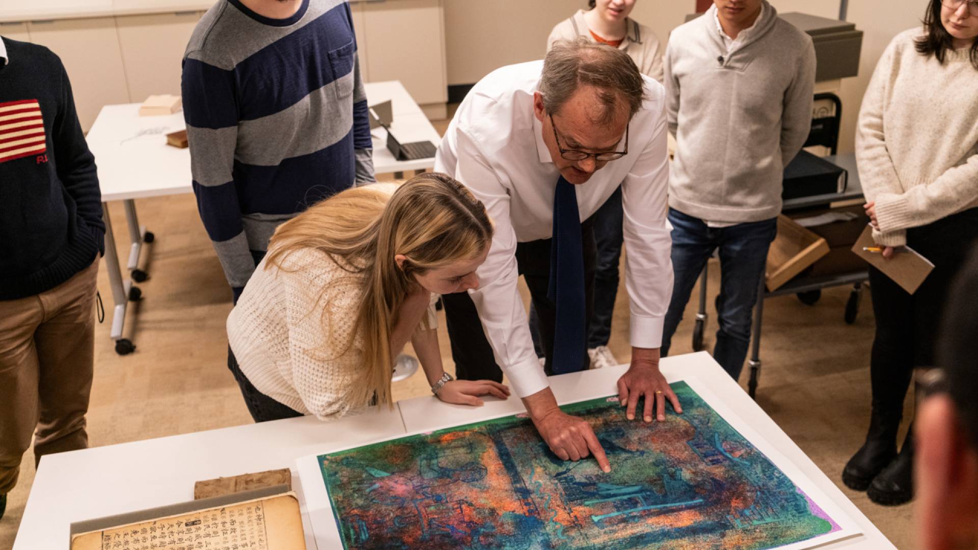 William Noel (right), the John T. Maltsberger III ’55 Associate University Librarian for Special Collections, shows undergraduate and graduate students a detail from a medieval manuscript housed at Princeton University Library's Department of Special Collections.