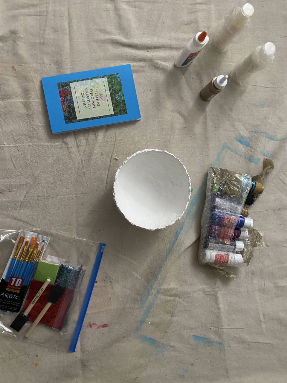Handmade bowl surrounded by craft supplies