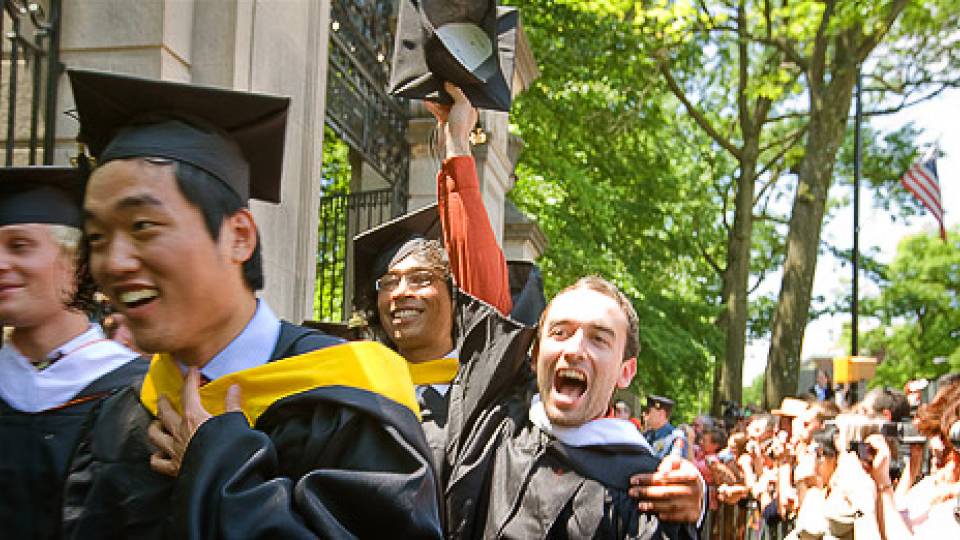 Graduates marching through the gates