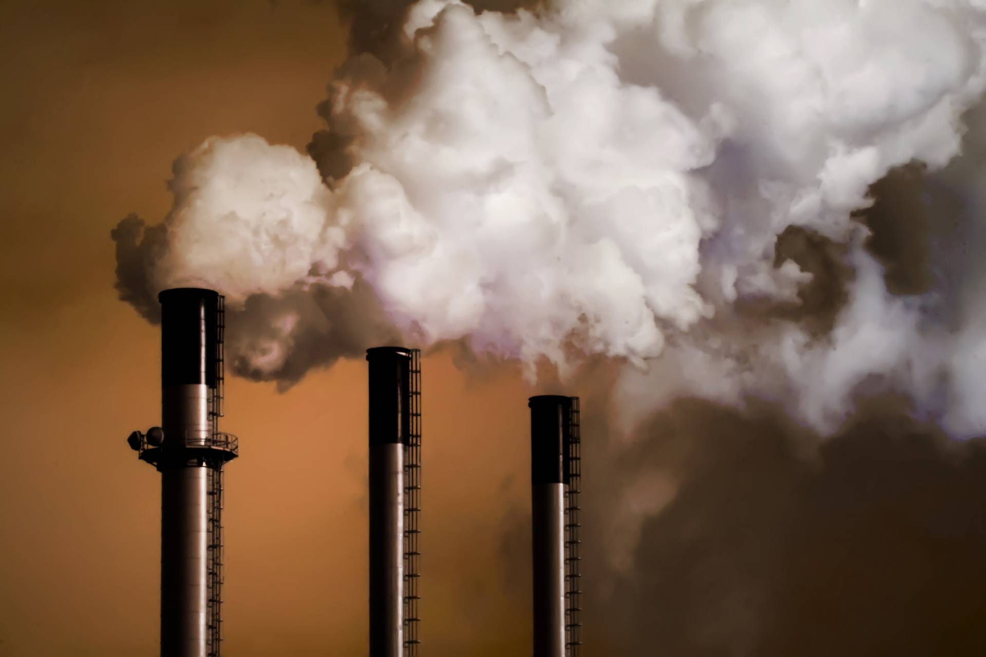 3 smokestacks belching white smoke