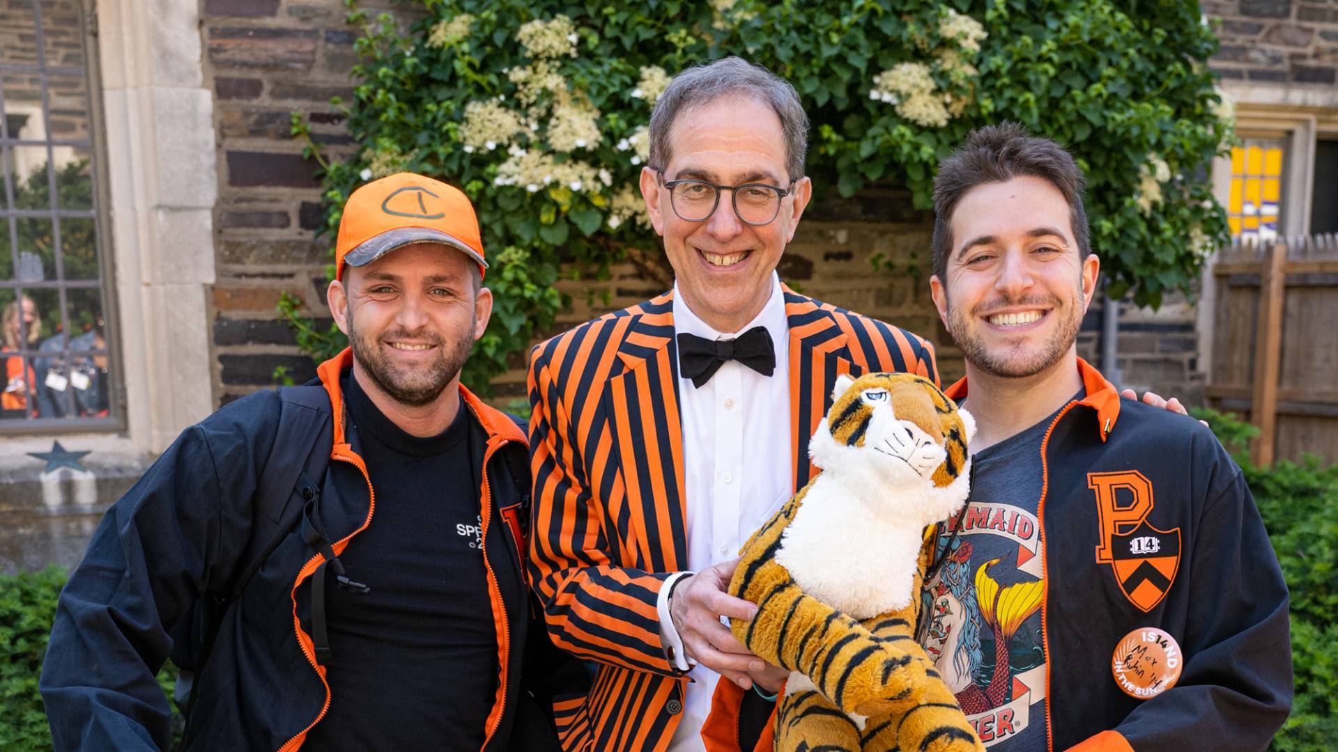 President Eisgruber flanked by alumni